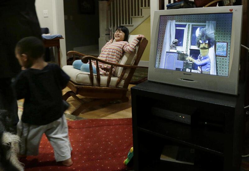 Elizabeth Jensen, 6, center, and her brother Joe Jensen, 2, left, are given the special afternoon treat of a little TV time, Tuesday, Feb. 12, 2013 at their home in Seattle. A study out this week online in the journal Pediatrics says parents who want kids
