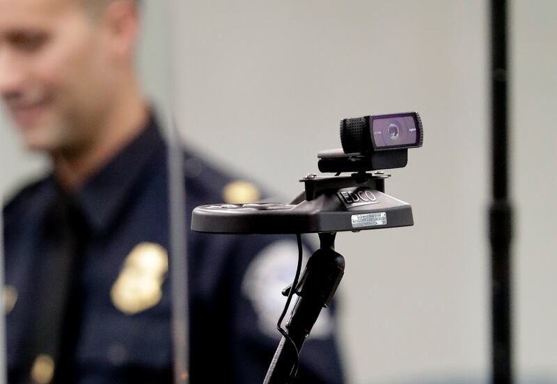 FILE - In this June 21, 2018 file photo, a face recognition camera is seen at the customs entry at Orlando International Airport in Orlando, Fla. Computers started to be able to recognize human faces in images decades ago. But now artificial intelligence
