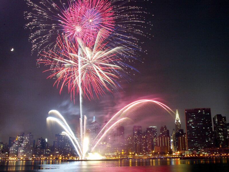 Fireworks light up the sky over New York's East River, looking from Queens towards Manhattan, during the annual Fourth of July event, Friday, July 4, 2003. The Chrysler building is seen to the right and the Empire State Building is partially obscured cent