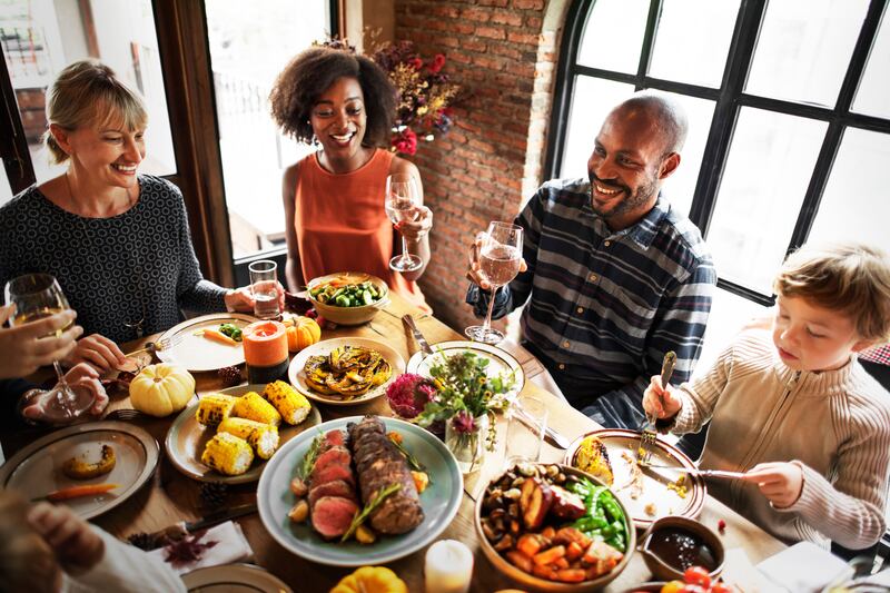 Friends are shown enjoying Thanksgiving dinner.