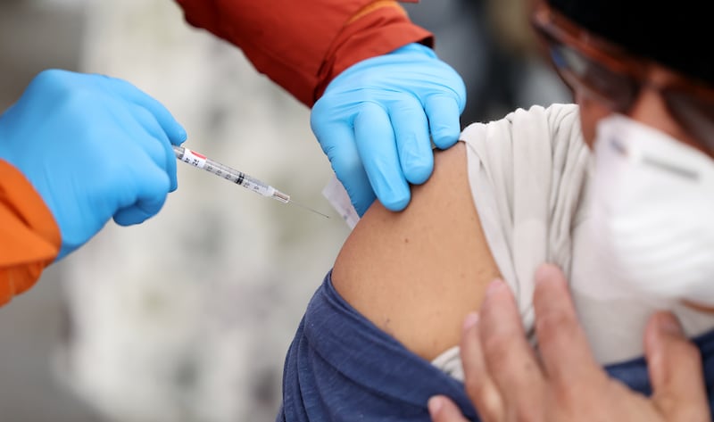 Tristin Torkelson gives a COVID-19 vaccination.