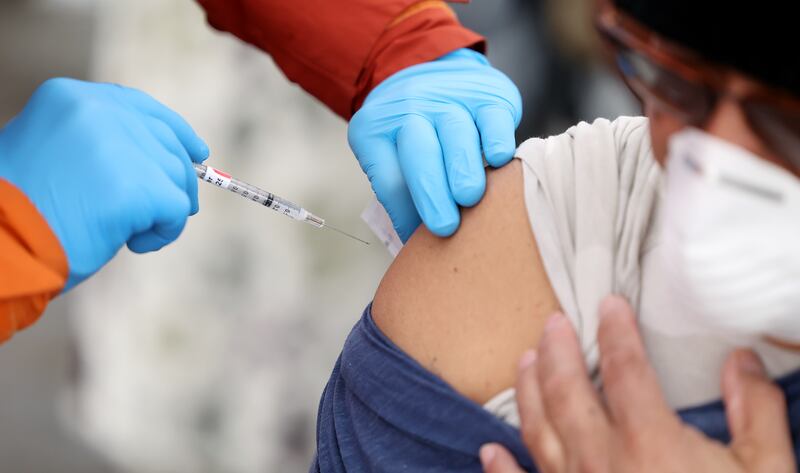 Tristin Torkelson gives a COVID-19 vaccination.