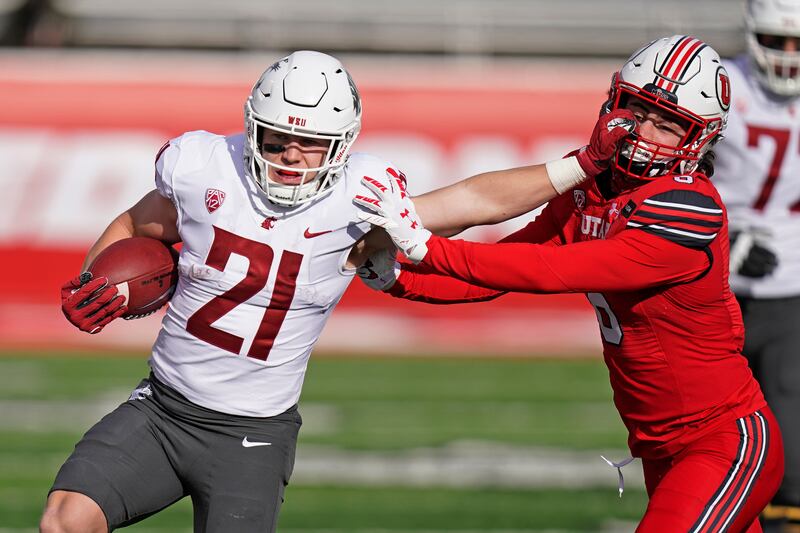 Utah safety Nate Ritchie, right, reaches to tackle Washington State’s Max Borghi Dec. 19, 2020, in Salt Lake City.