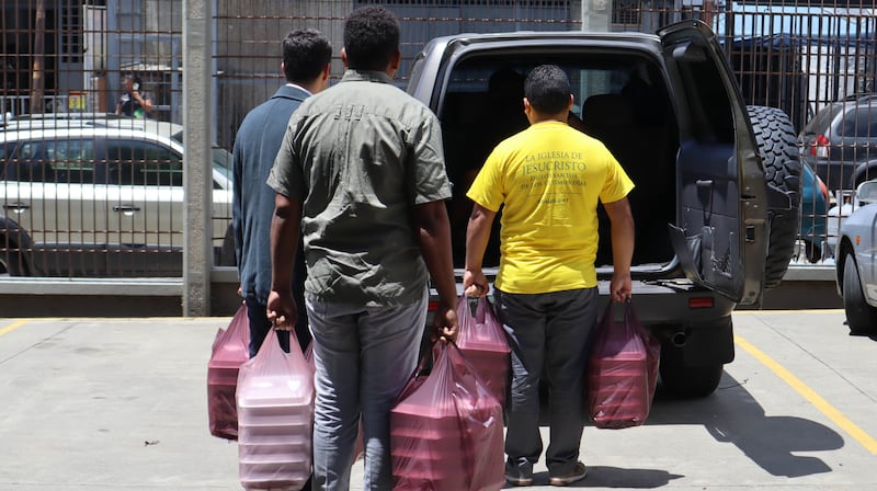 Volunteers from The Church of Jesus Christ of Latter-day Saints carry prepared meals to be delivered to those in need on July 1, 2026, in La Guaira, Venezuela.