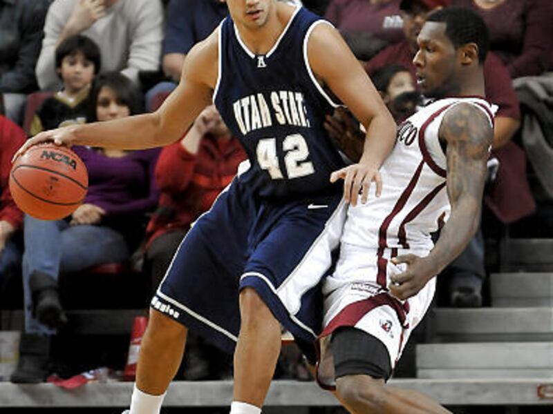 Utah State's Tai Welsey backs down New Mexico State's Wendell McKines Saturday night in the Aggies 55-52 loss to NMSU at the Pan American Center to open WAC play.