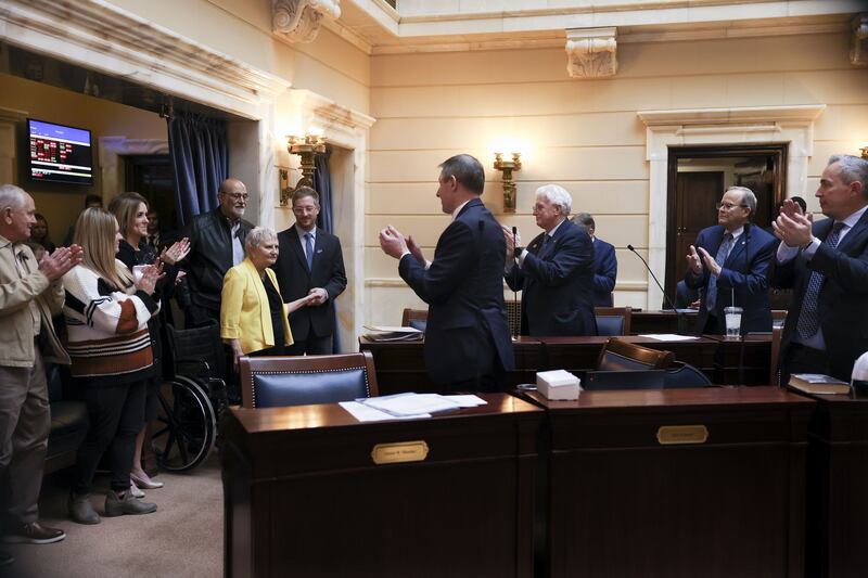 Former Sen. Karen Mayne receives a standing ovation in the Senate after a bill that creates a scholarship for law enforcement officers passed at the Capitol in Salt Lake City on Friday. The scholarship is named after Mayne, who retired earlier this year.