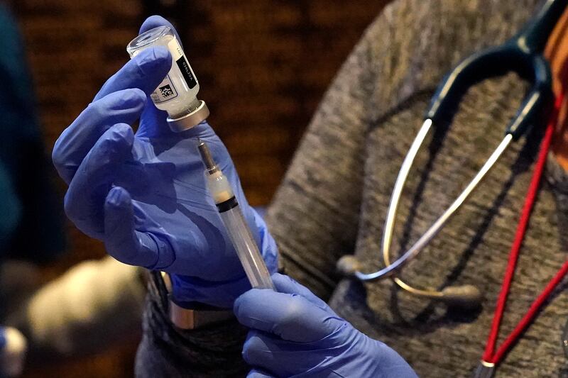 A dose of the Moderna COVID-19 vaccine is placed into a syringe, Wednesday, Dec. 30, 2020, in Boston.