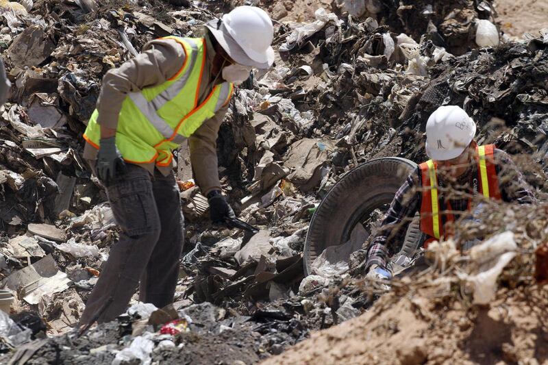 Workers sift through trash in search for decades-old Atari 'E.T. the Extra-Terrestrial' game cartridges in Alamogordo, N.M., Saturday, April 26, 2014. Producers of a documentary dug in an southeastern New Mexico landfill in search of millions of cartridge