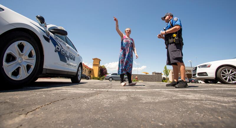 Unified police officer Jeff Fenton talks with Jennica Martinez after witnessing her running down the street yelling at her husband, Caesar Martinez, on Monday, June 3, 2019. Midvale is considering withdrawing from the Unified Police Department based on sa