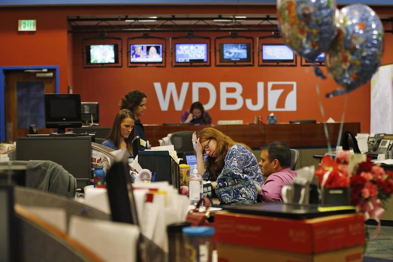 Members of the WDBJ-TV7 news staff prepare for the early morning newscast at the station, in Roanoke, Va., Thursday, Aug. 27, 2015. A reporter and cameraman from the station were killed during a live broadcast Wednesday, by a former colleague.