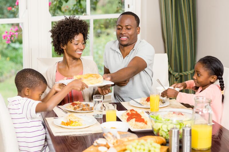 A family is shown eating together at mealtime.
