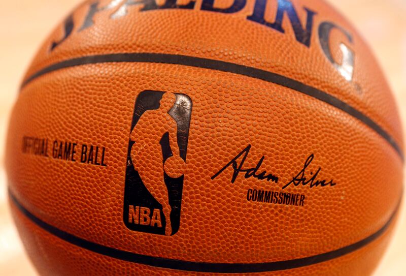 An NBA logo is seen on an official game ball before a basketball game, Feb. 1, 2014, in New York. The NBA said Wednesday, July 24, 2024 that it is not accepting Warner Bros. Discovery's $1.8 billion per year offer to continue its longtime relationship with the league and therefore has entered into a deal with Amazon Prime Video, a move that would mean this coming season would end a nearly four-decade run of games being on TNT.