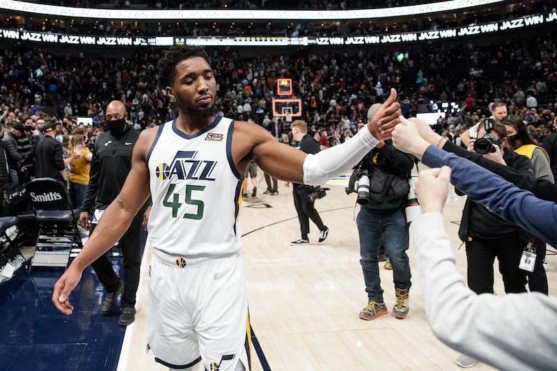 Utah Jazz guard Donovan Mitchell fist-bumps fans after a game against the Charlotte Hornets at Vivint Arena in Salt Lake City.