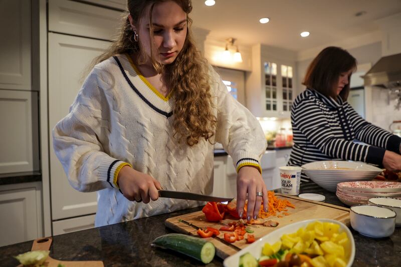 Eva Malezhyk prepares dinner in Salt Lake City on Thursday, March 31, 2022.