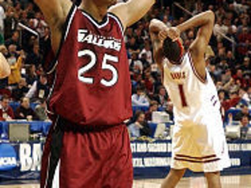Southern Illinois' Stetson Harrison (25) and Alabama's Chuck Davis react at the end of Alabama's 65-64 win on Thursday afternoon.