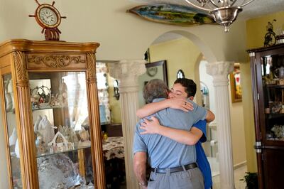 Jorge Daniel Alvarado hugs his grandfather, Miguel Angel Alvarado Santos, at Santos' home in Ponce, Puerto Rico, on Saturday, Dec. 9, 2017.