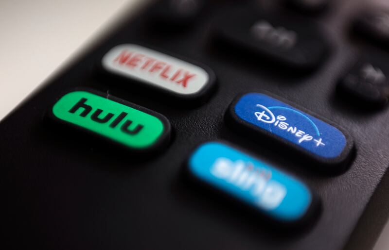The logos for Netflix, Hulu, Disney Plus and Sling TV are pictured on a remote control in Portland, USA.