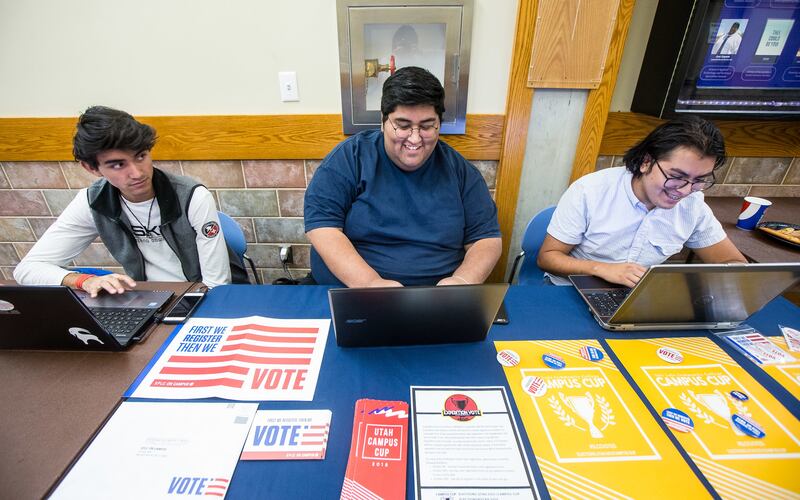 Luis Alvarez, left, Joel Zepeda and Alvaro Vasquez help students register to vote at the Salt Lake Community College Student Center in Taylorsville on Friday, Oct. 12, 2018.