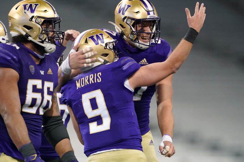 Washington quarterback Dylan Morris celebrates with tight end Cade Otton after an Otton touchdown reception against Utah.