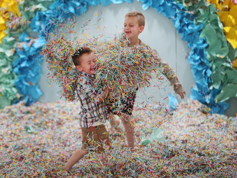 Hendrix Bingham and and his brother Bentley Bingham play in confetti at Gateway's new "Love Letters" pop-up exhibit in Salt Lake City on Wednesday, June 26, 2019.