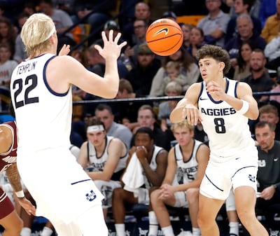Utah State guard Drake Allen (8) passes to teammate Karson Templin during the Aggies' 95-83 win over Montana on Nov. 18 at the Spectrum in Logan.