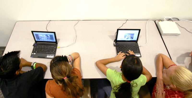 Students use small computers to connect to the internet, during the launch of the Comcast Internet Essentials program, designed to bring broadband internet to families in need, at a press conference at Rose Park Elementary School in Salt Lake City Monday, October 3, 2011. (Brian Nicholson, Deseret News)