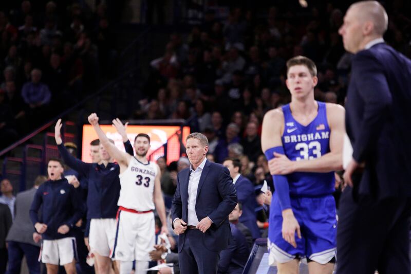Gonzaga coach Mark Few, center, and BYU head coach Mark Pope, right, look on during game in Spokane, Wash., Jan. 18, 2020.