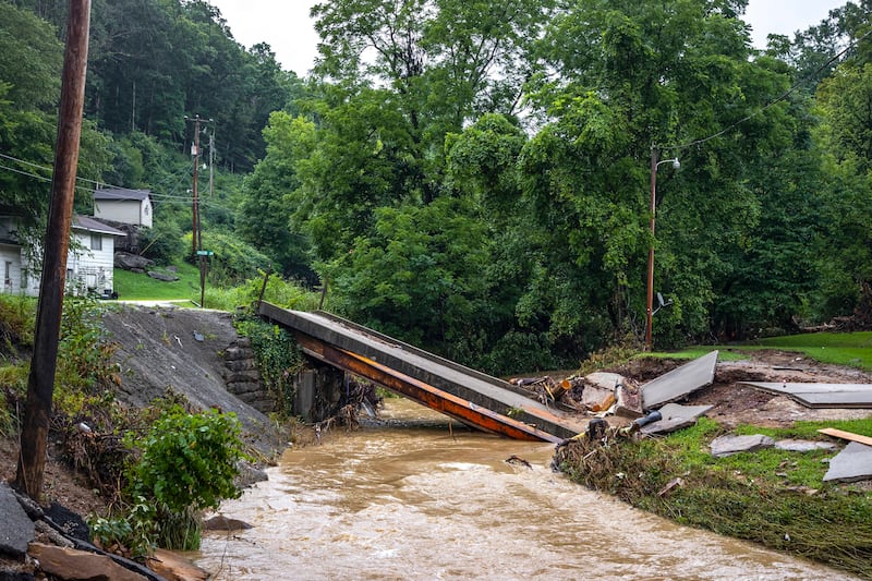 A bridge across Grapevine Creek to a home near Grapevine, Ky., is collapsed Monday, Aug. 1, 2022, following historic floods.