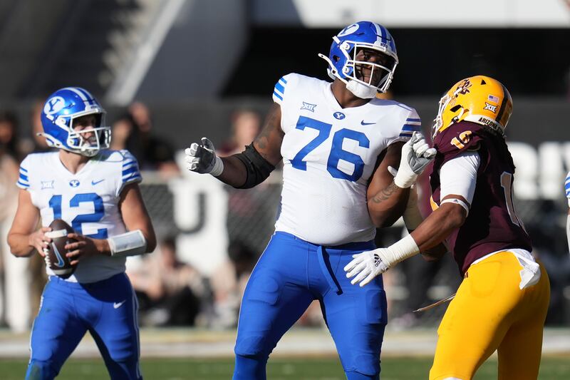 BYU offensive lineman Caleb Etienne (76) blocks Arizona State defensive lineman Clayton Smith Saturday, Nov. 23, 2024, in Tempe, Ariz.