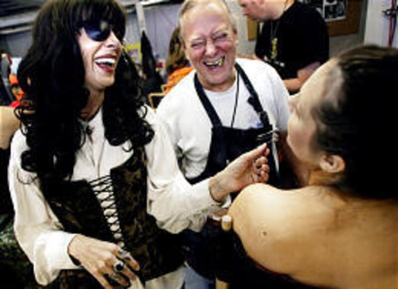 While wearing pirate attire Cydney Neil, left, catches a laugh with makeup artist Max Weiss and actress Laura Schafer back stage at Rocky Point Haunted House. This is Neil's last year doing Rocky Point in South Salt Lake.