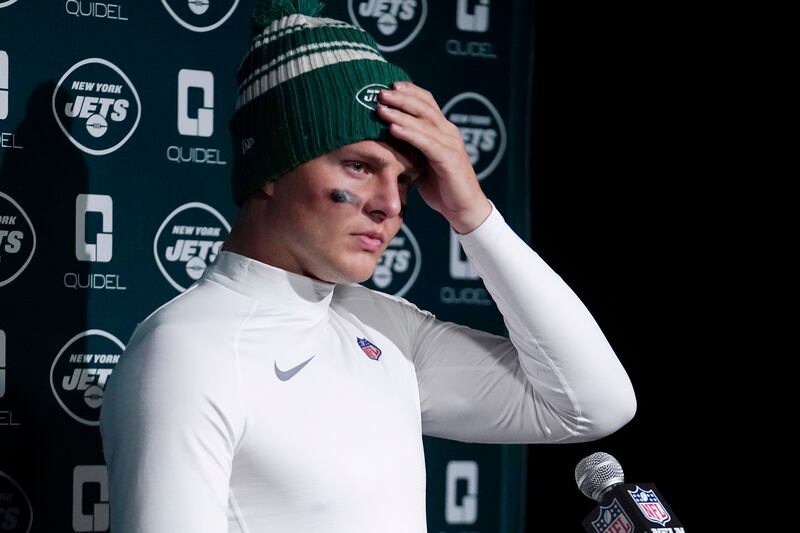 New York Jets quarterback Zach Wilson talks with reporters following a 10-3 loss to the New England Patriots following an NFL football game, Sunday, Nov. 20, 2022, in Foxborough, Mass.