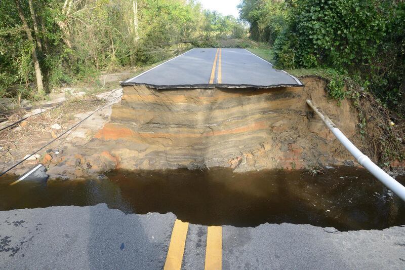 Falling Creek Road is unpassable Sunday, Oct. 9, 2016 after rains from Hurricane Matthew caused a portion of the road to collapse in Kinston, N.C.