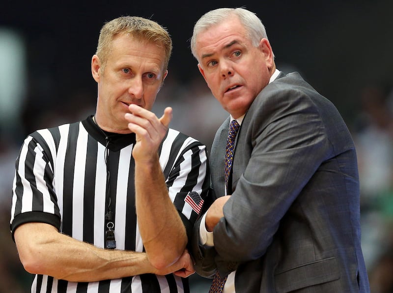 Brigham Young Cougars head coach Dave Rose has a talk with a referee as UVU and BYU play a College basketball game in the UCCU center at UVU in Orem Utah on Wednesday, Nov. 29, 2017.