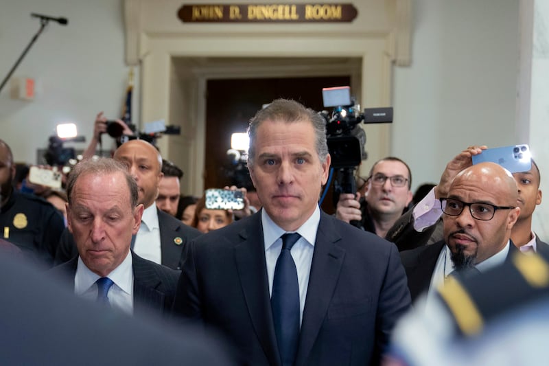 Hunter Biden and Abbe Lowell, right, leave a House Oversight Committee hearing on Capitol Hill on Wednesday in Washington.