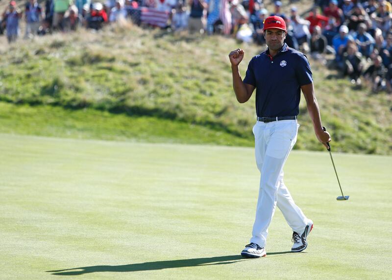 Tony Finau of the US reacts after going 5 up during a singles match on the final day of the 42nd Ryder Cup at Le Golf National in Saint-Quentin-en-Yvelines, outside Paris, France, Sunday, Sept. 30, 2018. (AP Photo/Alastair Grant)
