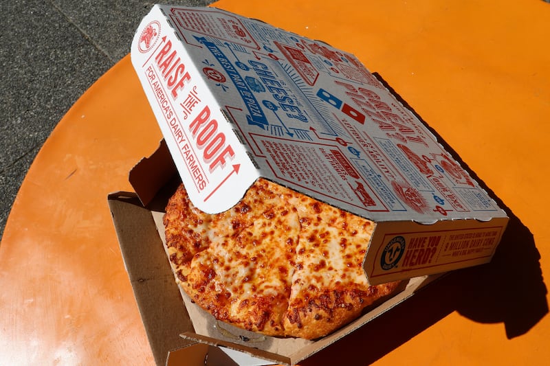 A small pizza made in a Domino’s Pizza shop.