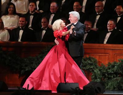 Kristin Chenoweth dances with a choir member while singing with the Tabernacle Choir at Temple Square during their opening Christmas concert in Salt Lake City on Thursday, Dec. 13, 2018.