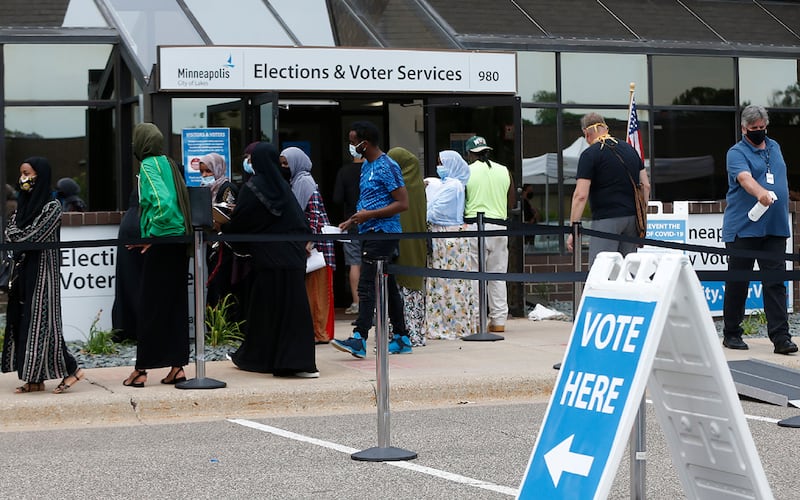 In this Aug. 10, 2020, file photo, Minneapolis voters line up to vote a day ahead of Minnesota’s Tuesday primary election at the Minneapolis Election and Voters Services offices.