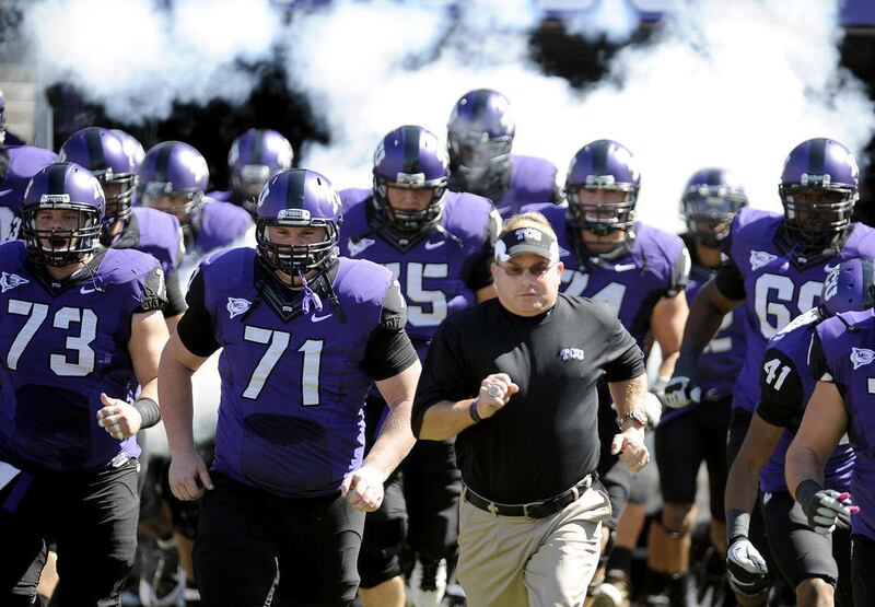 In this photo taken Saturday, Oct. 1, 2011, TCU head coach Gary Patterson runs onto the field with his team before an NCAA college football game against SMU in Fort Worth, Texas. Leaders of the Big 12 Conference cleared the way Thursday, Oct. 6, 2011, to
