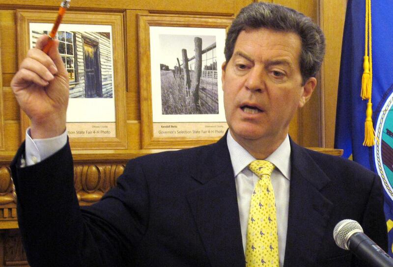 Kansas Gov. Sam Brownback makes a point in discussing the state's finances during a news conference, Wednesday, July 25, 2012, at the Statehouse in Topeka, Kan. Brownback argues that income tax cuts approved this year won't cause big budget problems in th