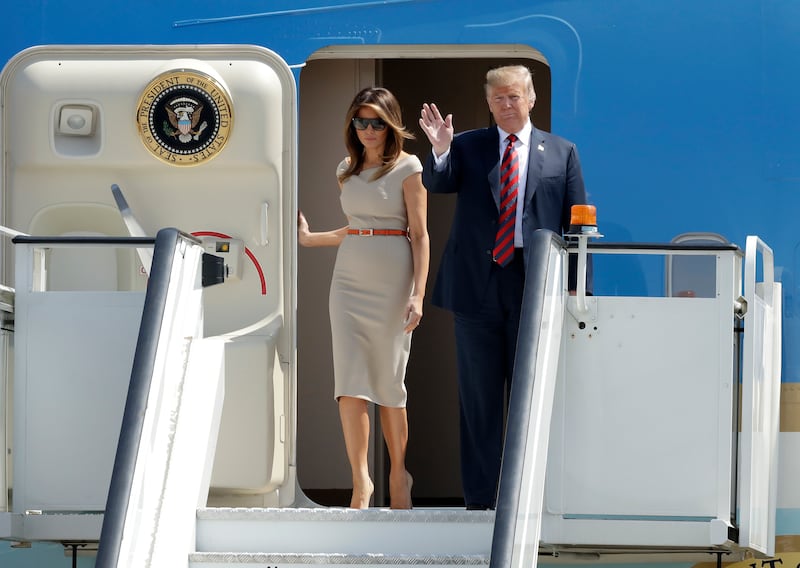 U.S. President Donald Trump and First Lady Melania Trump disembark from Air Force One as they arrive at London Stansted Airport in Stansted, England, Thursday, July 12, 2018. Trump is making his first trip to Britain as president after a tense summit with