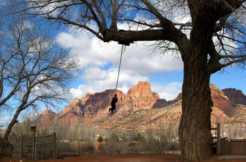 A young boy on a swing in Colorado City, Arizona on the Utah border next to the twin city of Hildale, Utah Thursday, Feb. 19, 2004.