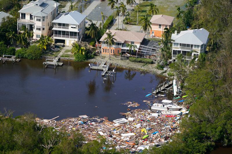 This aerial photo shows damaged homes and debris in the aftermath of Hurricane Ian in Fort Myers, Fla.