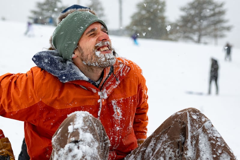 Anthony Roberts’ beard is coated in snow after sledding down a hill at Sugar House Park in Salt Lake City.