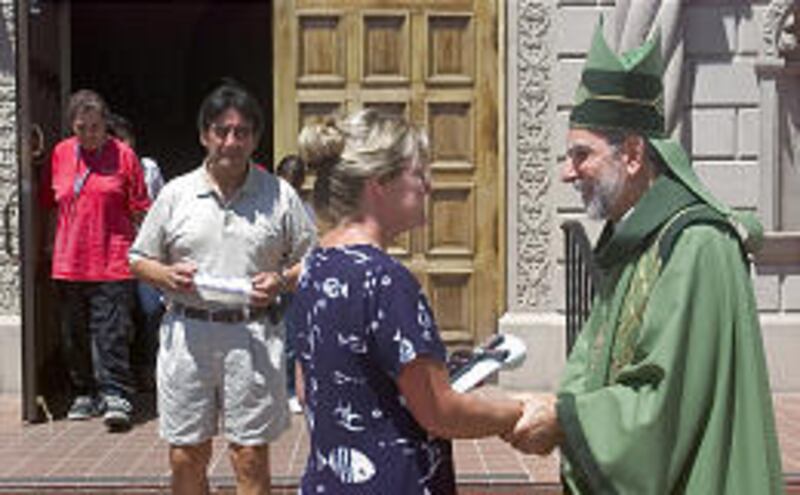 Bishop Gerald Kicanas speaks with parishioners after Mass at St. Augustine Cathedral in Tucson, Ariz.
