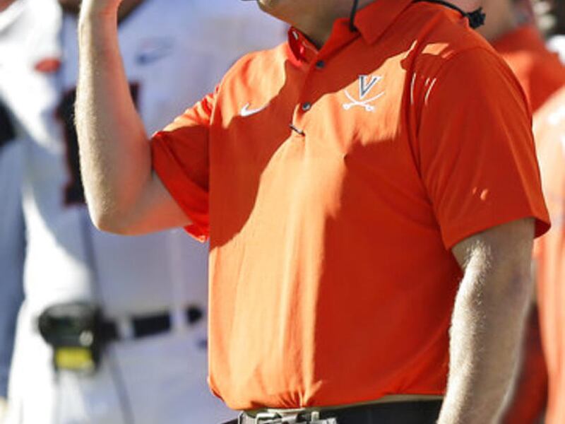 Virginia head coach Bronco Mendenhall signals from the sideline during the first half an NCAA college football game against North Carolina in Chapel Hill, N.C., Saturday, Oct. 14, 2017. (AP Photo/Gerry Broome)