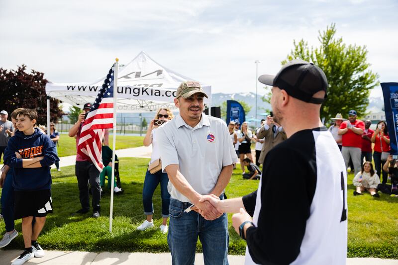 Retired U.S. Army Sgt. William Davis III accepts the keys to a new car at Ellison Park in Layton on June 17, 2023.