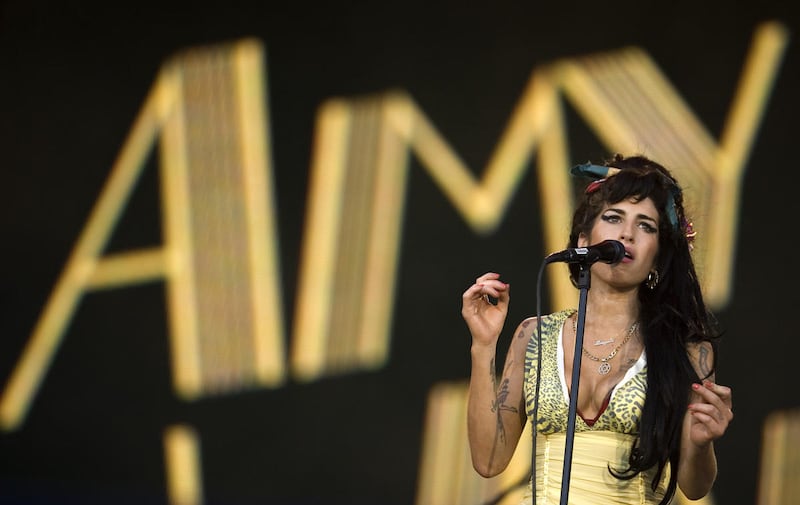 In this July 4, 2008 file photo, singer Amy Winehouse of England performs during the Rock in Rio music festival in Arganda del Rey, on the outskirts of Madrid. British police say singer Amy Winehouse has been found dead at her home in London on Saturday,