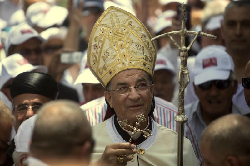 Cardinal Bechara Rai, the head of Lebanon’s Maronite Catholics, marches with supporters to a church in the ruins of the village of Kufr Birim, northern Israel, Wednesday, May 28, 2014. It was one of two politically charged visits to disparate Maronite flo