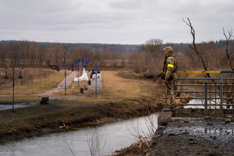 A Ukrainian soldier stands guard near Kyiv.